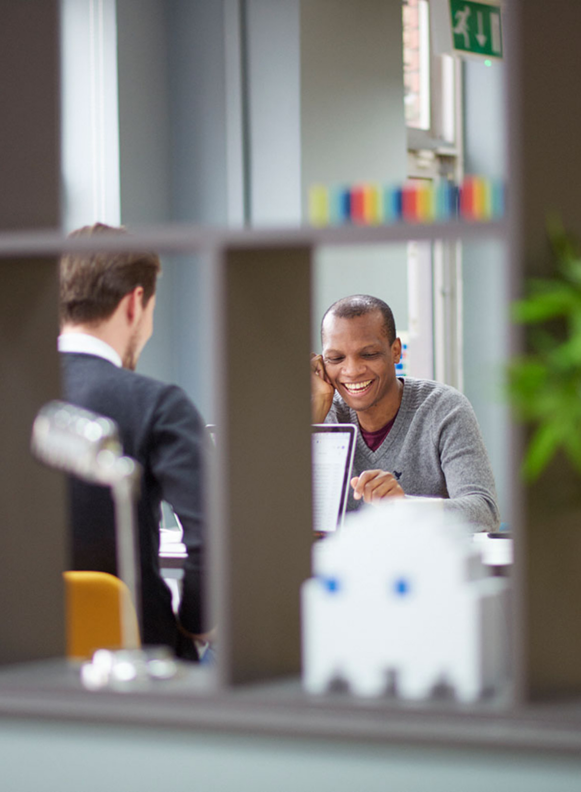 Qa Test analyst discussing website progress with a developer